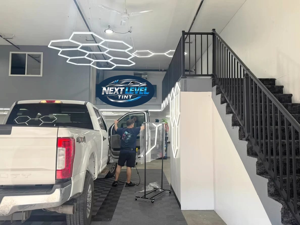 Inside the Next Level TINT shop during a window tint install
